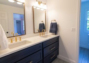 Second Floor Bathroom, navy cabinets with gold mirror