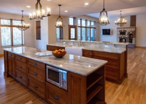 Two large kitchen islands open into living area