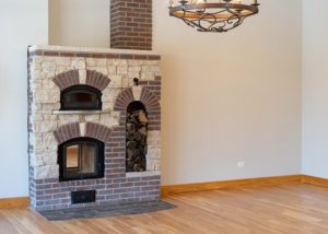 Double sided Masonry heater in living room that looks like a fireplace