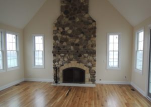 Custom built country home - open concept living space with field stone fireplace