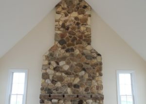 Custom built country home - field stone fireplace