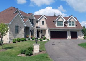 Custom built luxury home - front of house - ivory brick with red roof