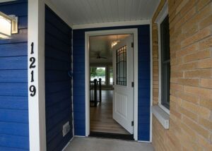 Front Door with Brick and Blue Siding