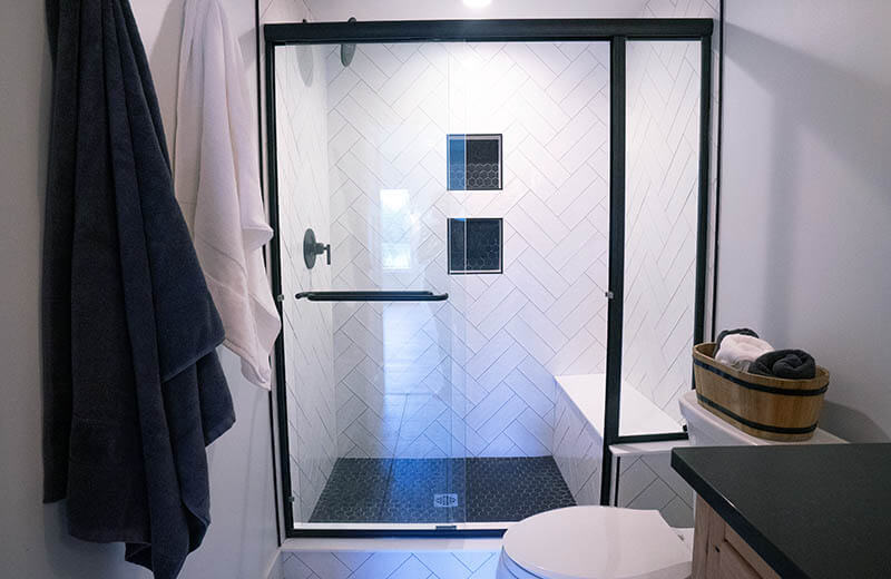 Basement shower with white tile