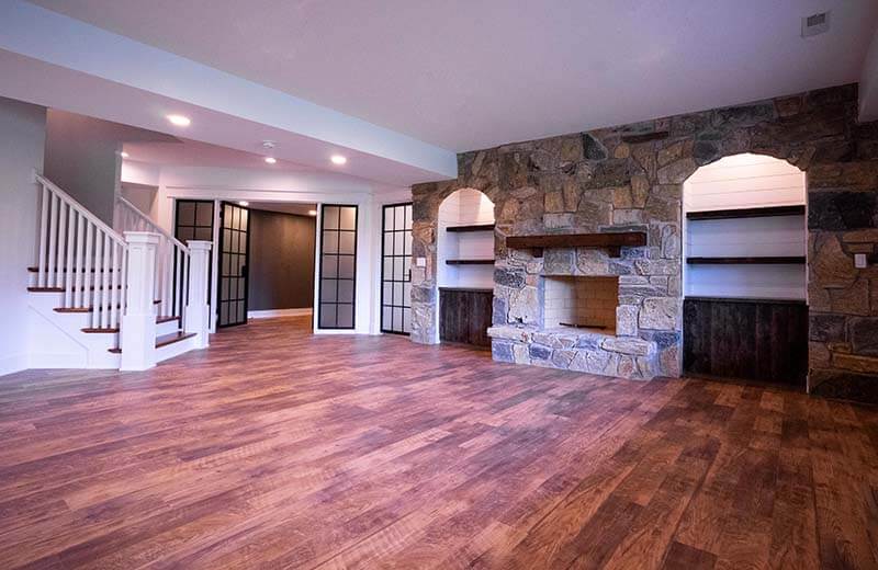 Refinished basement with stone fireplace