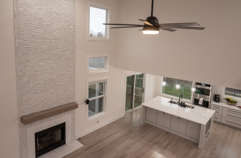View from above of remodeled kitchen and living room with fireplace
