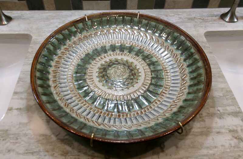 Handmade platter made out of pottery is the inspiration for color and texture for both bathroom remodels