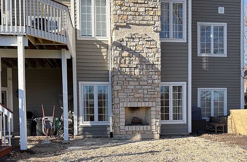 Outdoor patio showing patio and fireplace before the construction of the porch