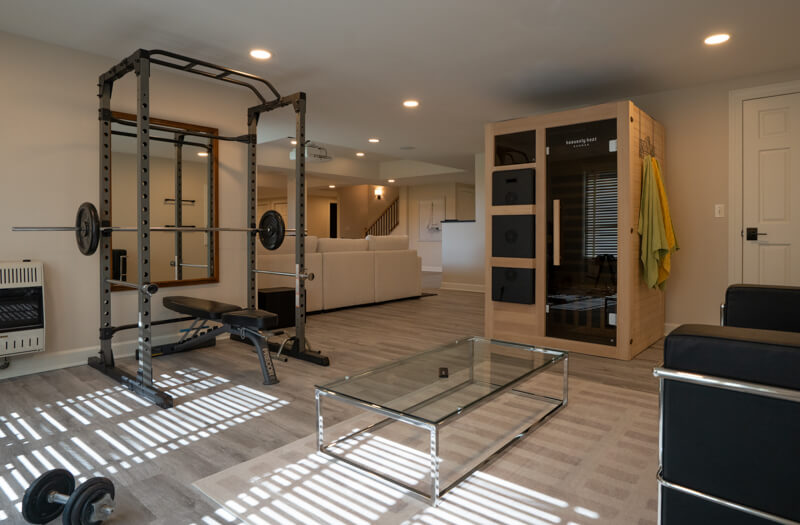 Workout area with portable sauna in basement