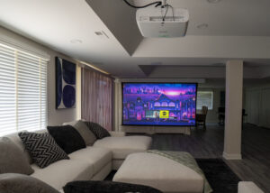 retractable screen in entertainment area for watching movies, sports and television